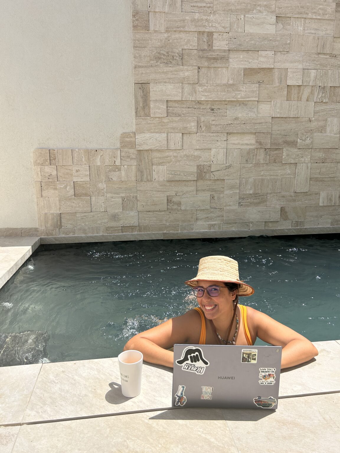 Working on a laptop by the pool in Djerba