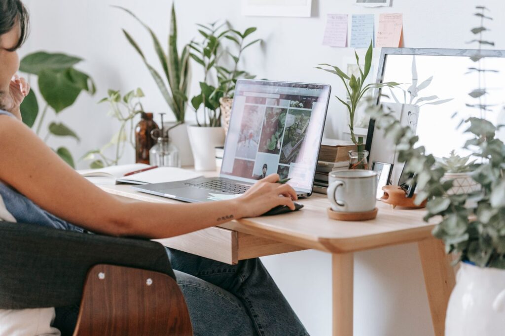 Woman working calmly and focused at her desk with plants