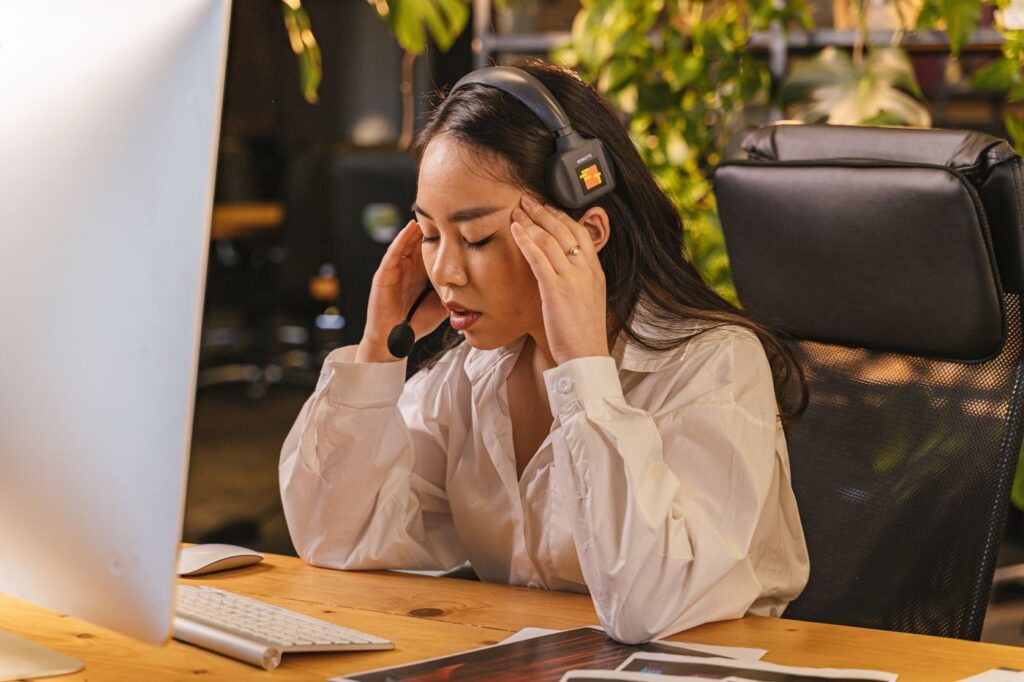 Woman feeling exhausted at her work desk
