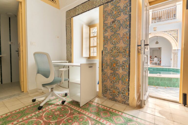 Work desk overlooking the courtyard pool at Dar Fenina, Hammamet